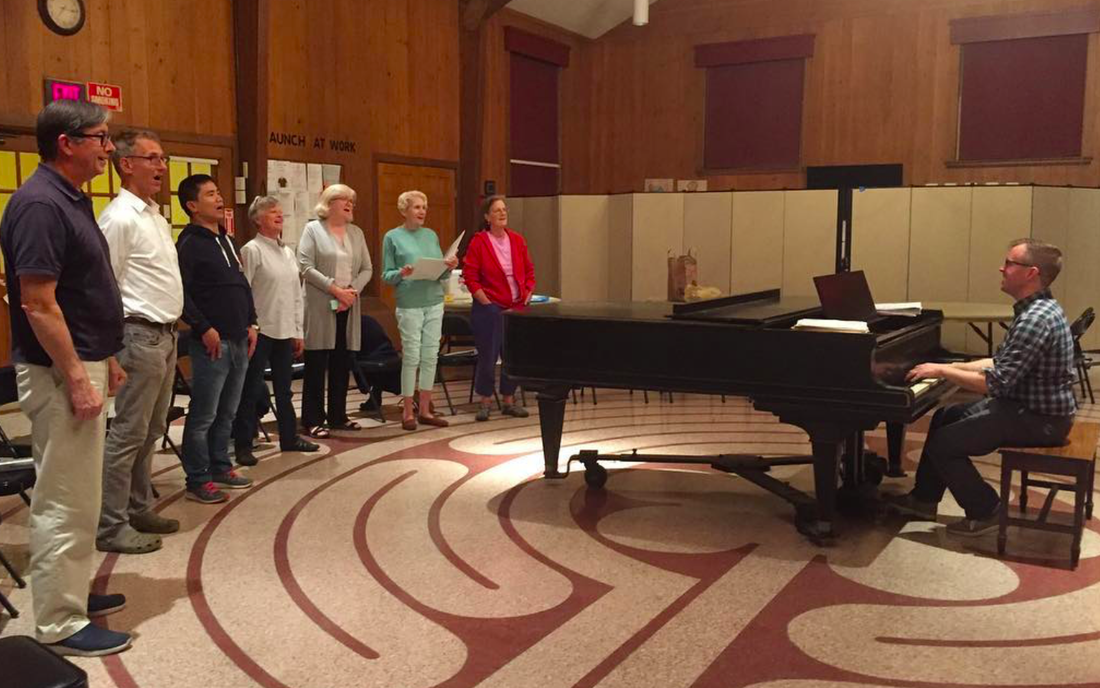 Music Director Christopher Hossfeld leads choir practice on the Fellowship Hall labyrinth.